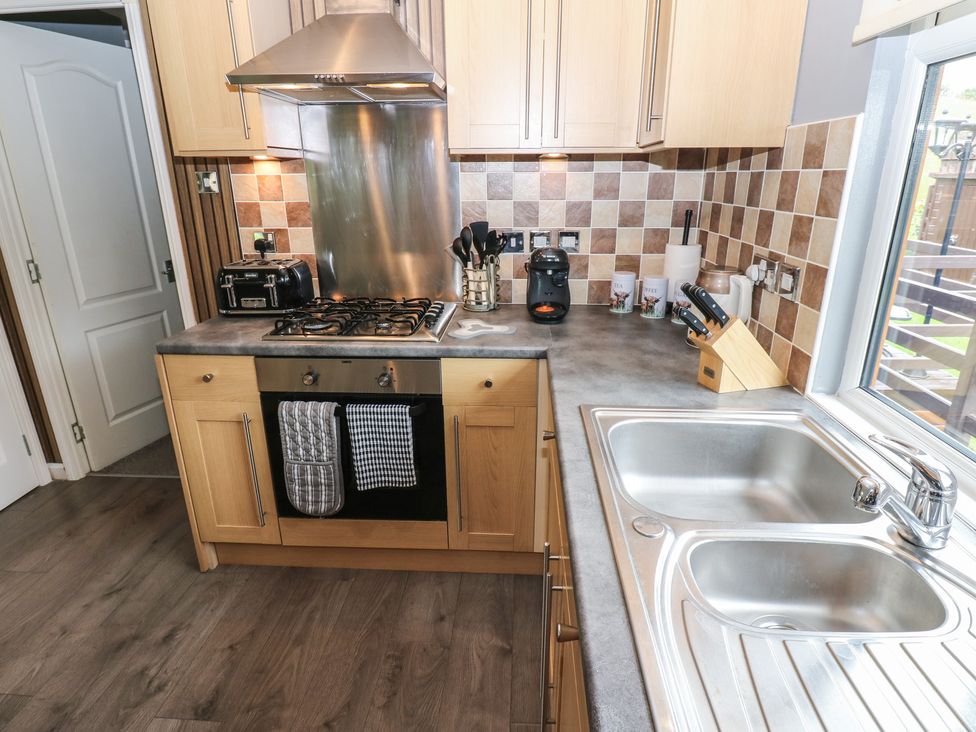 A kitchen with a gas stove and sink at 16 Badgers Retreat in Richmond