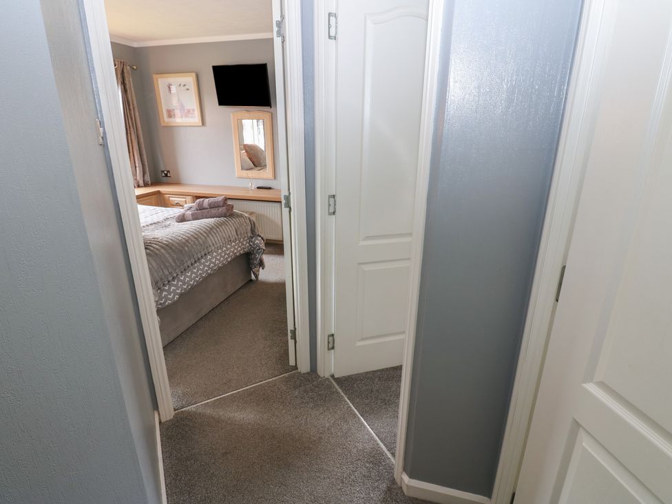 A bedroom view showing a bed and a mirror at 16 Badgers Retreat in Richmond