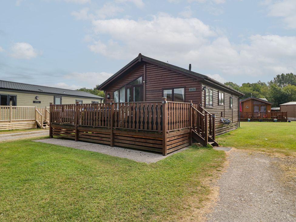A log cabin with a deck at The Cedars South Lakeland Leisure Village