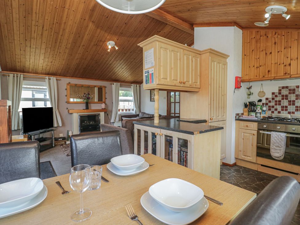 A kitchen with dining area at The Cedars in South Lakeland Leisure Village