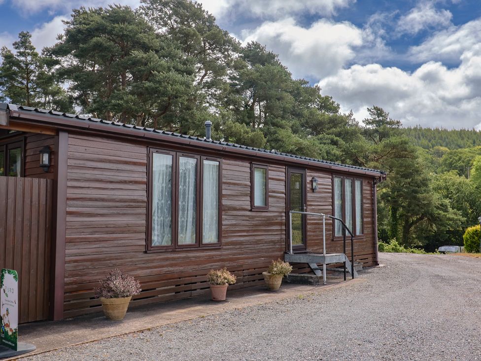A cottage exterior with steps and planters at The Cabin at East Hill Pride, Four Elms Hill Nr. Sidmouth