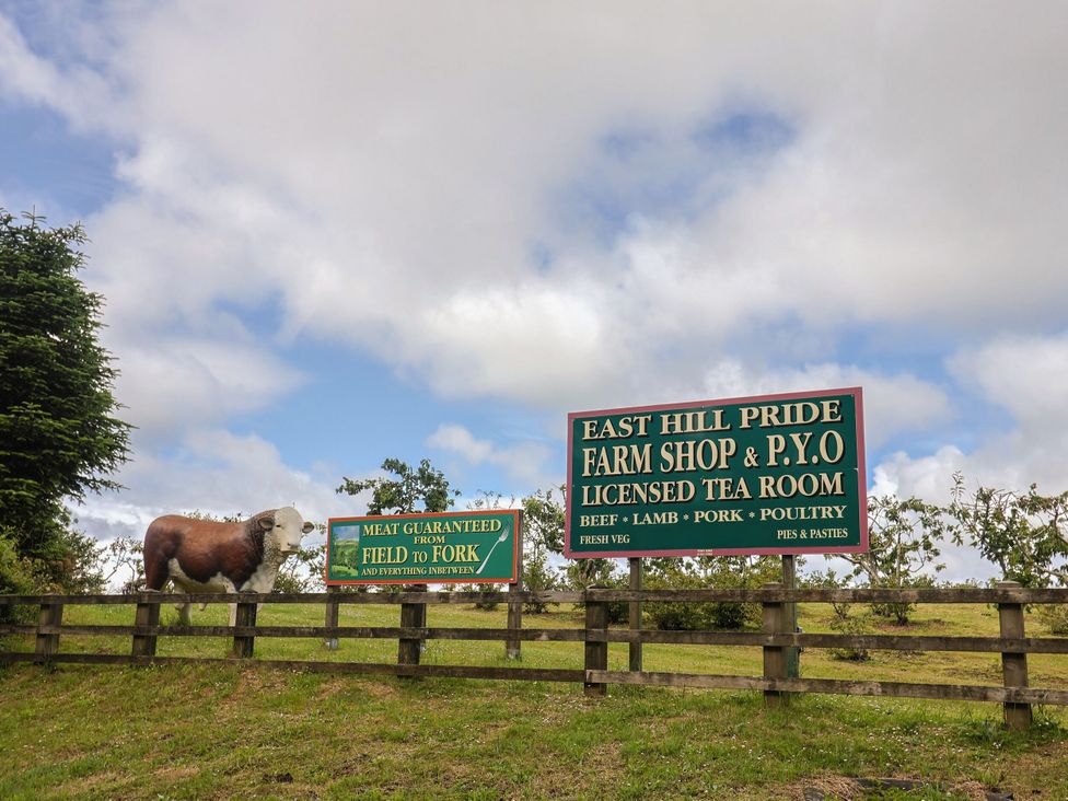 A farm shop sign with cow statue at East Hill Pride Four Elms Hill Nr. Sidmouth