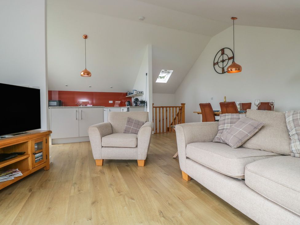 A living room with a sofa and television at Coney Garth Retreat in Beckermet