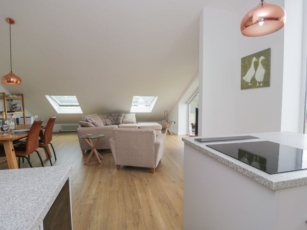 A living room with a sofa and dining table at Coney Garth Retreat in Beckermet