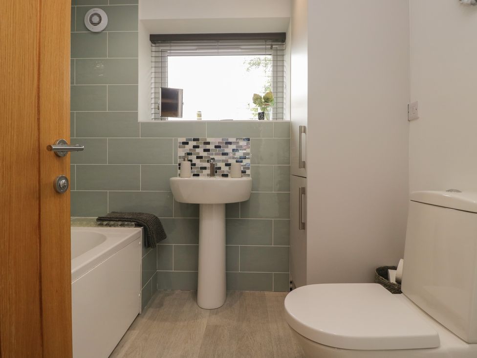 A bathroom with a sink and bathtub at Coney Garth Retreat in Beckermet