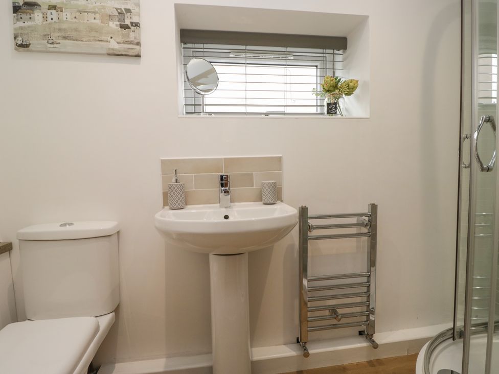 A bathroom with a sink and toilet at Coney Garth Cottage Beckermet