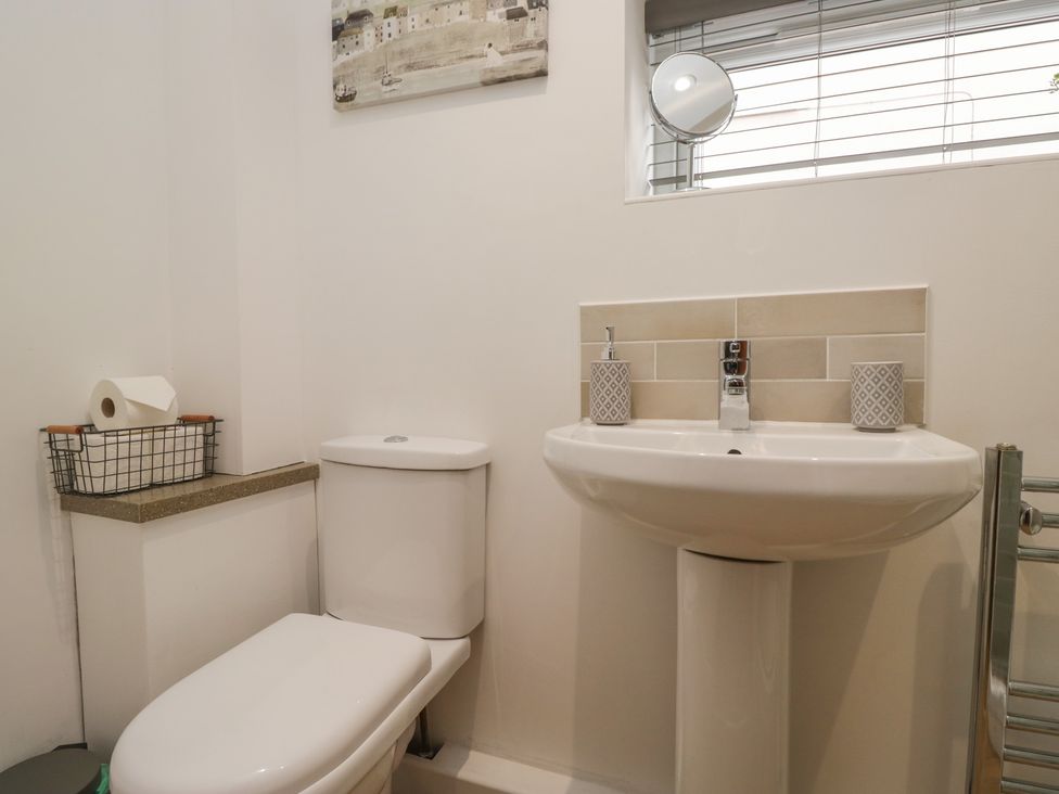 A bathroom with a toilet and sink at Coney Garth Cottage in Beckermet