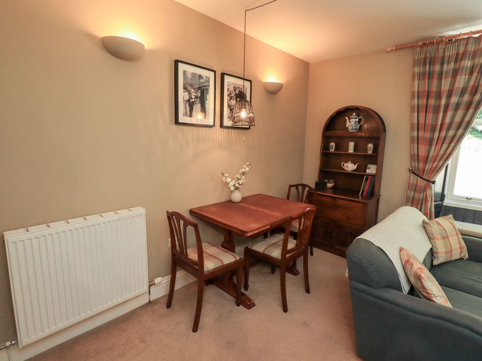A dining area with a table and chairs at The Cells Ingleton