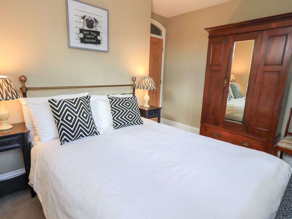 A bedroom with a bed and bedside tables at The Cells in Ingleton