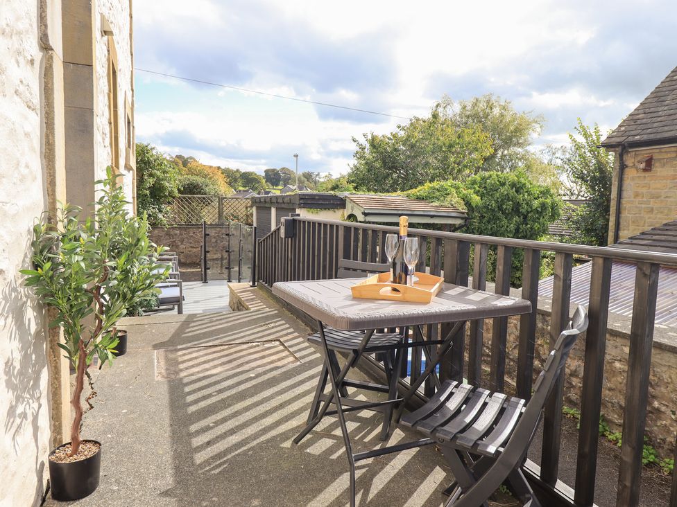 A patio area with a table and chairs at The Cells Ingleton
