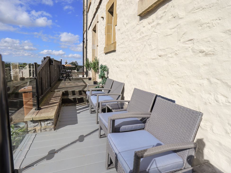 A deck with chairs and a table at The Cells Ingleton