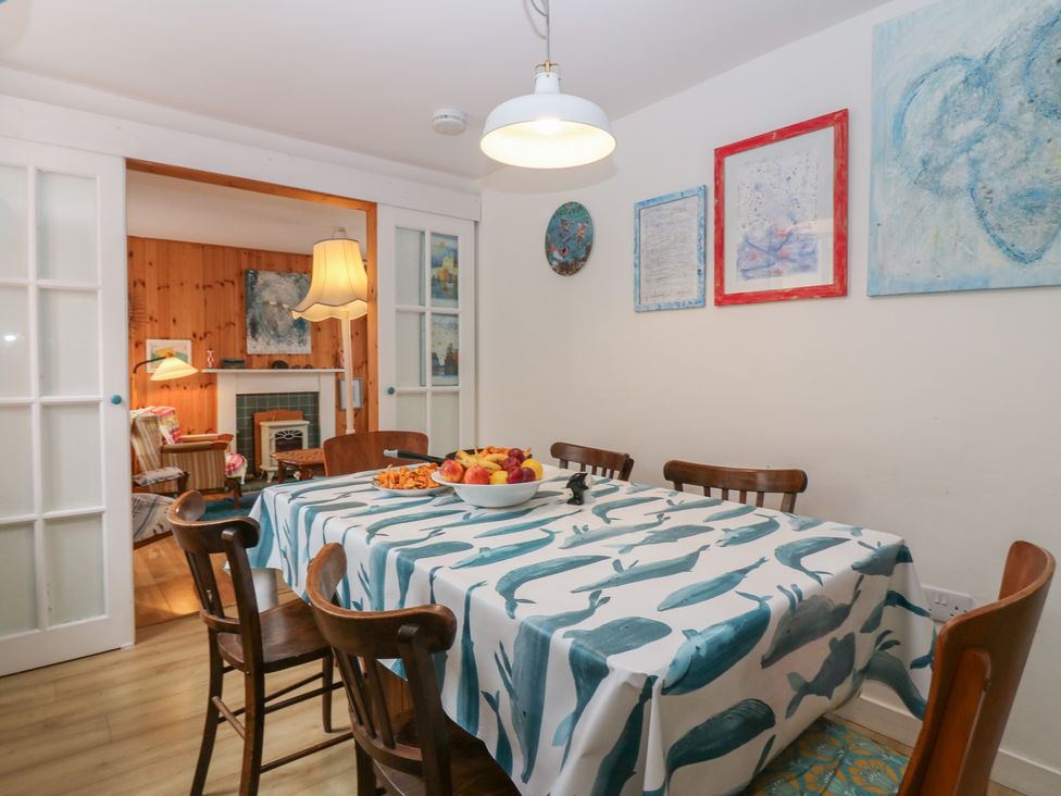A dining room with a table and fruit bowl at Dookers Hoose in Cullen