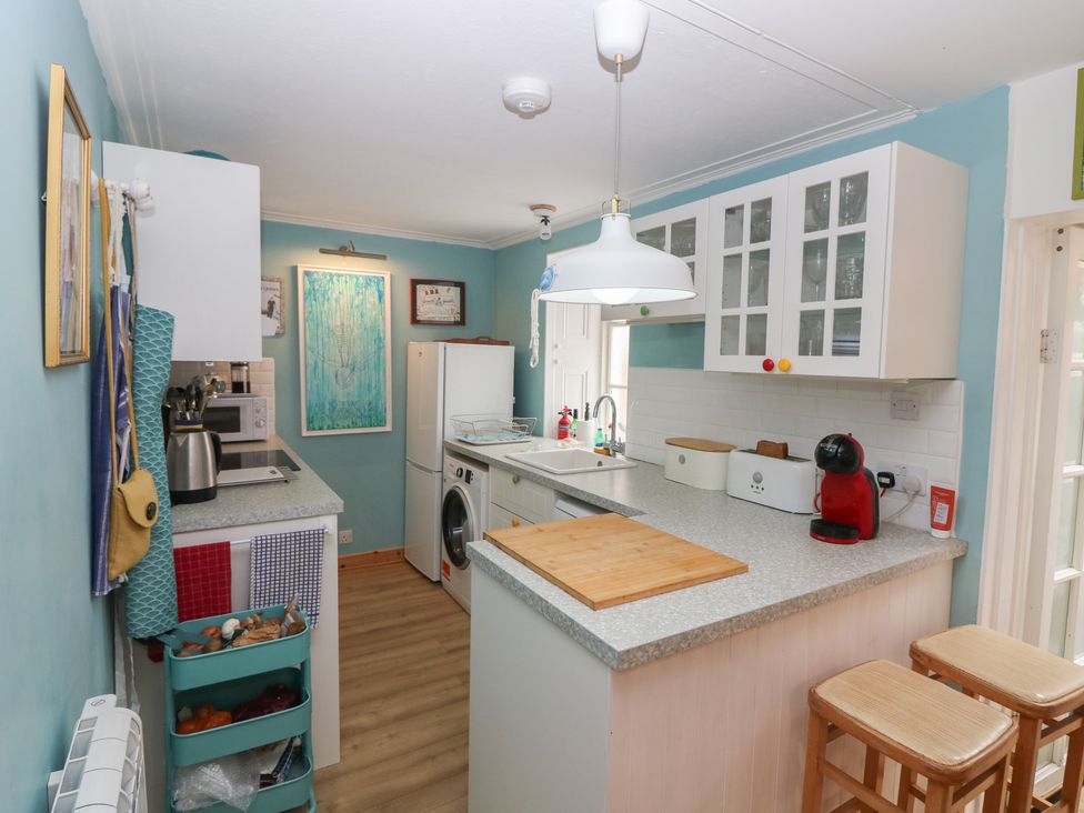 A kitchen with appliances and a countertop at Dookers' Hoose in Cullen