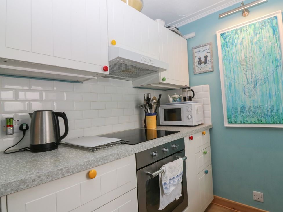 A kitchen with kettle, microwave, and cooking hob at Dookers Hoose Cullen