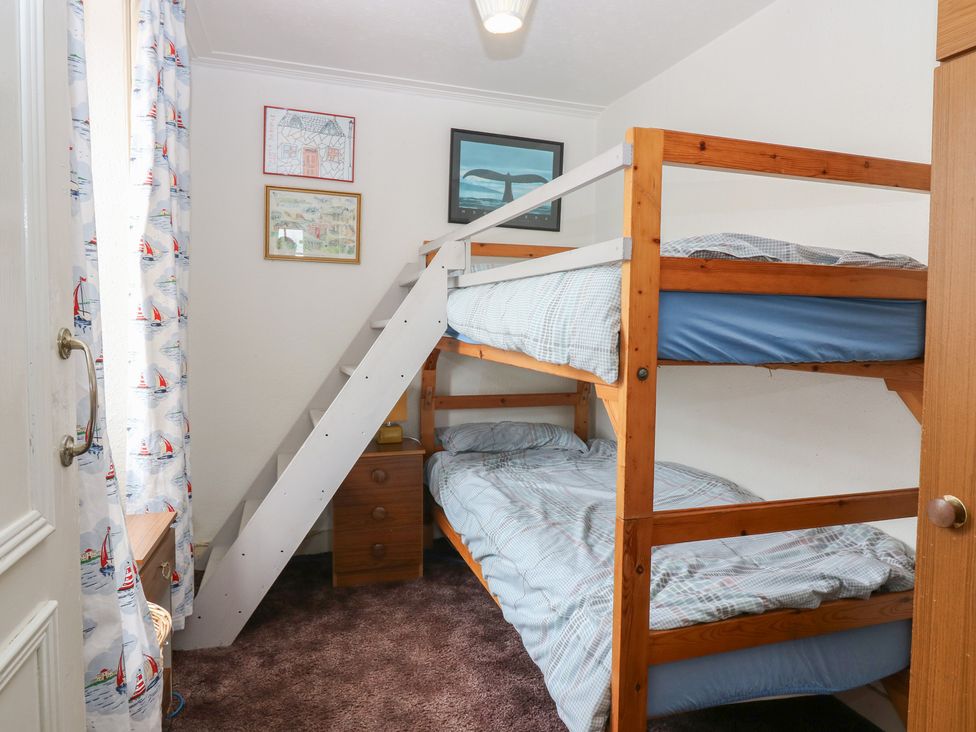 A bedroom with a bunk bed and drawers at Dookers' Hoose in Cullen