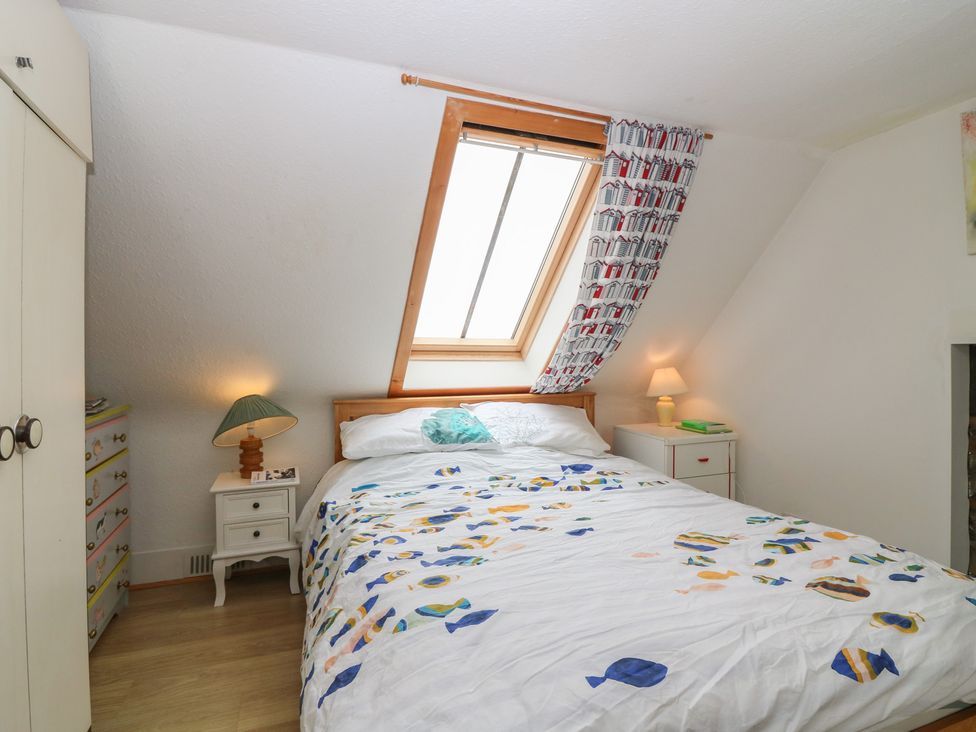 A bedroom with a bed and a window at Dookers' Hoose in Cullen