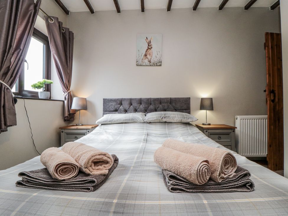 A bedroom with a bed and towels on the sheets at Carters in Staintondale