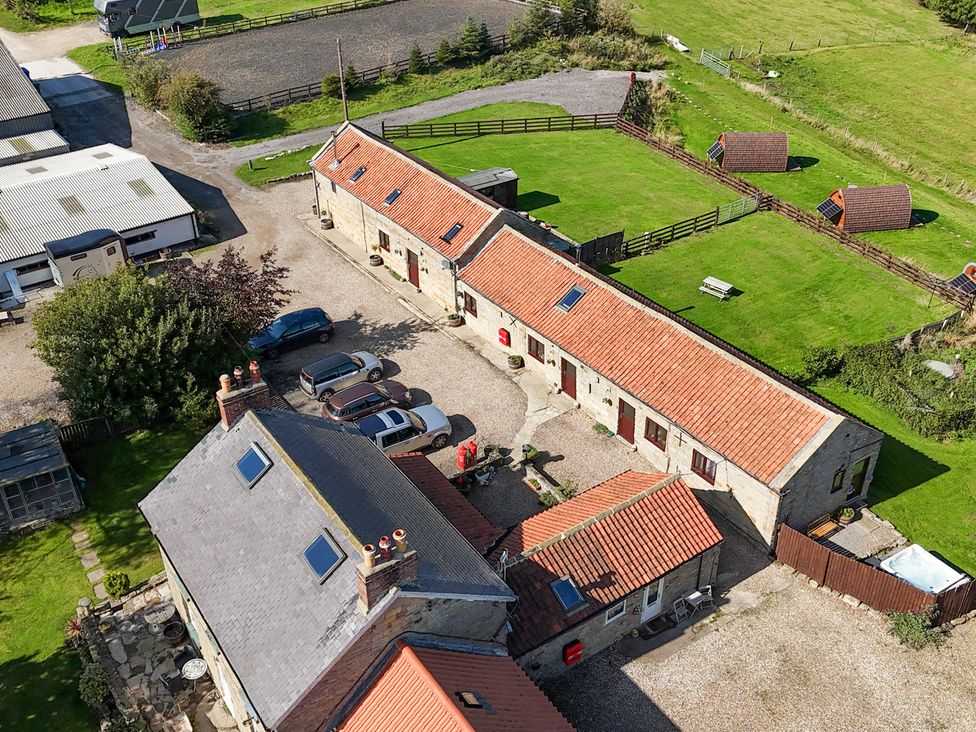 An outdoor area with multiple buildings and vehicles at Hayloft in Staintondale