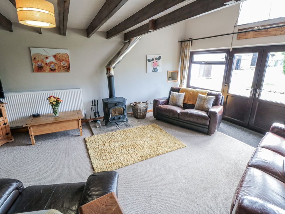 A living room with a coffee table and sofa at Hayloft in Staintondale