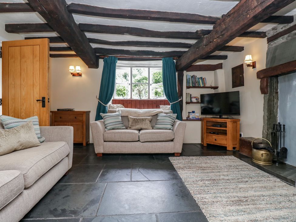 A living room with a sofa and TV at Rose Cottage in Broughton-In-Furness
