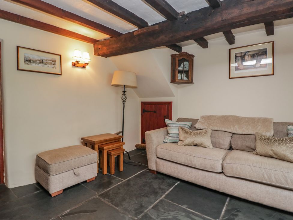 A sitting room with a sofa and side tables at Rose Cottage in Broughton-In-Furness