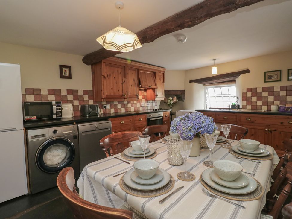 A kitchen with a table set for dining at Rose Cottage in Broughton-In-Furness