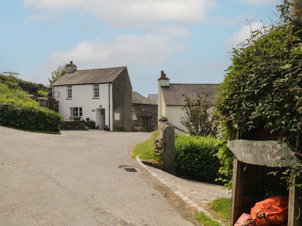 A house on a road with greenery at Rose Cottage in Broughton-In-Furness