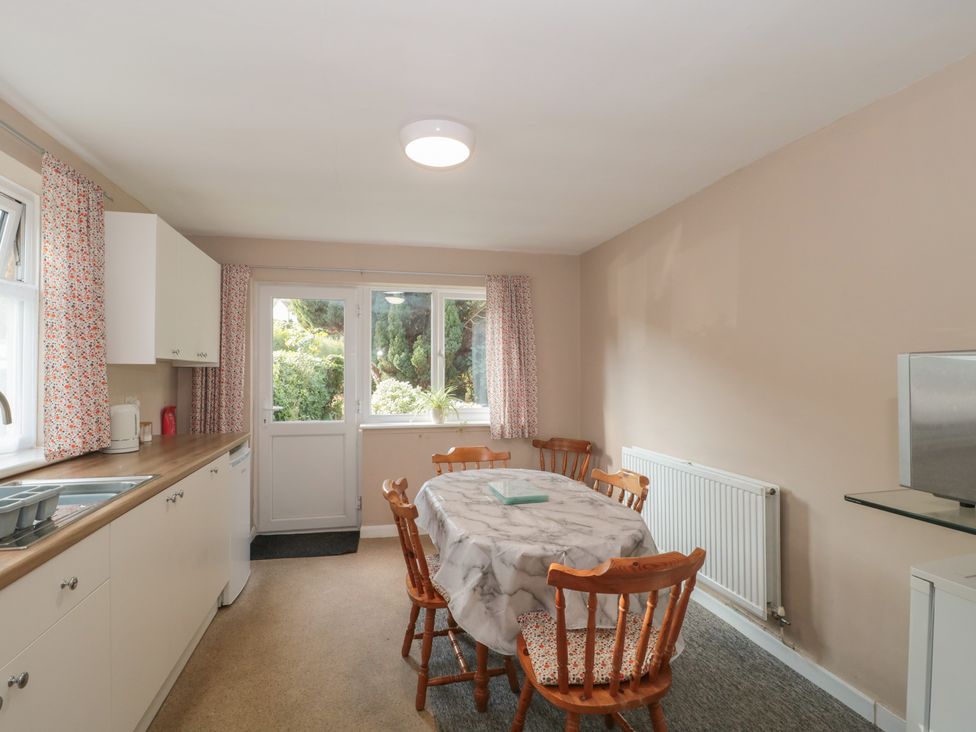 A kitchen with a table and chairs at 1 Westcroft Cottage in King's Stanley