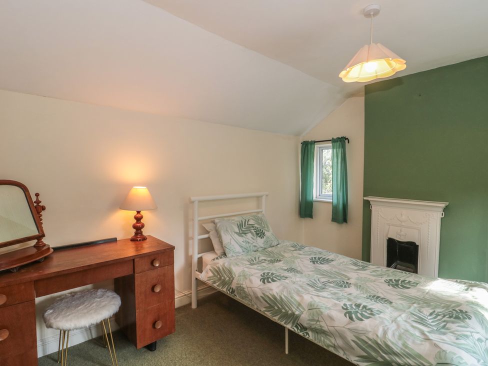 A bedroom with a bed and desk at 1 Westcroft Cottage King's Stanley