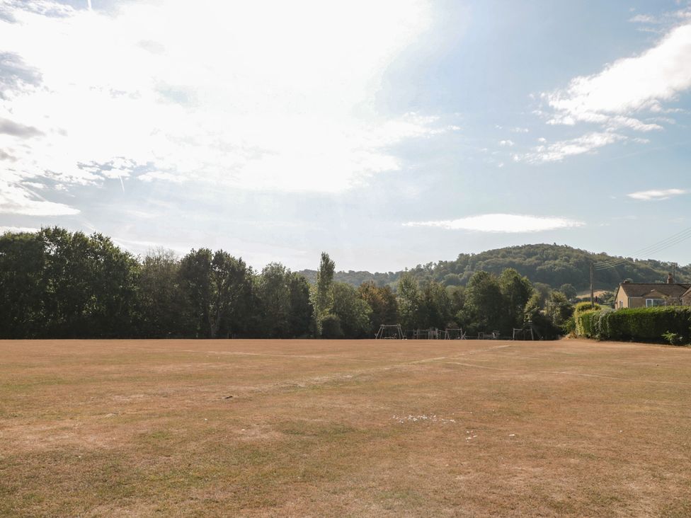 A field with trees and a hill in the background at 1 Westcroft Cottage King's Stanley