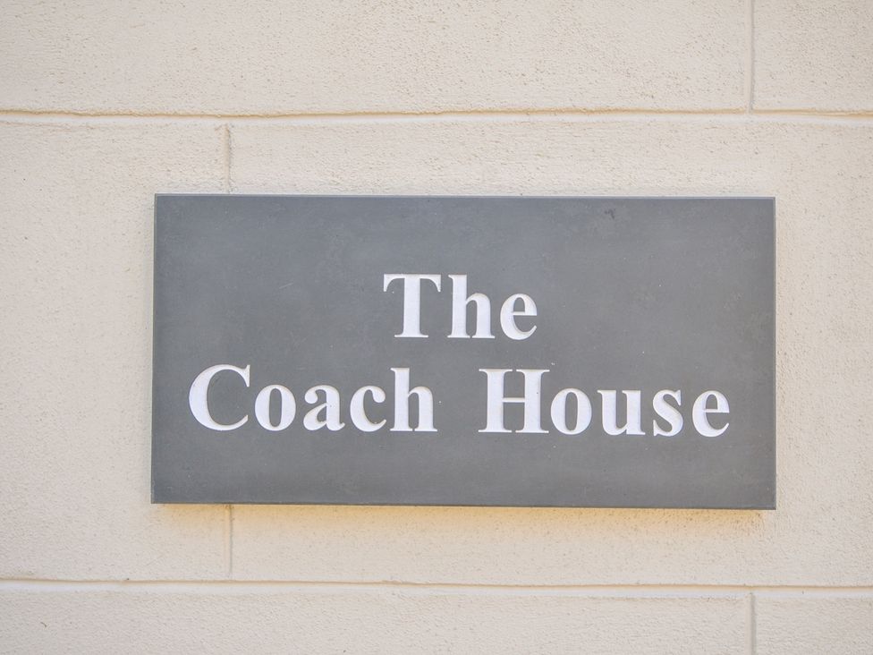 A sign showing The Coach House at Pendower House Fowey