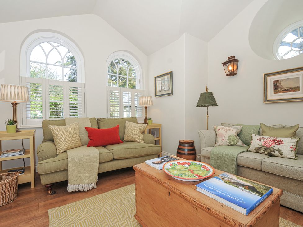 A living room with sofas and a coffee table at The Coach House at Pendower House Fowey