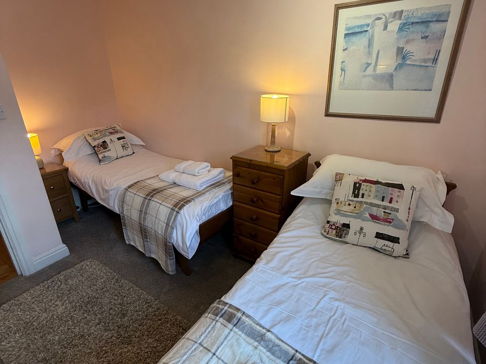 A bedroom with two single beds and a dresser at Sandy Bottoms in Whitby