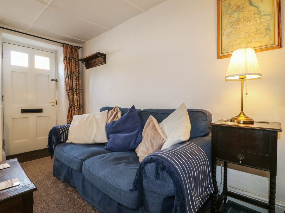 A living room with a sofa and lamp at The Hill in Cromford