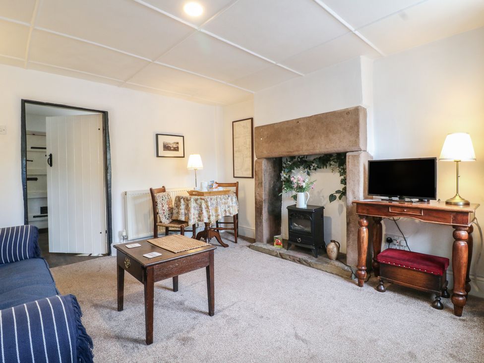 A living room with a table and chairs at The Hill in Cromford