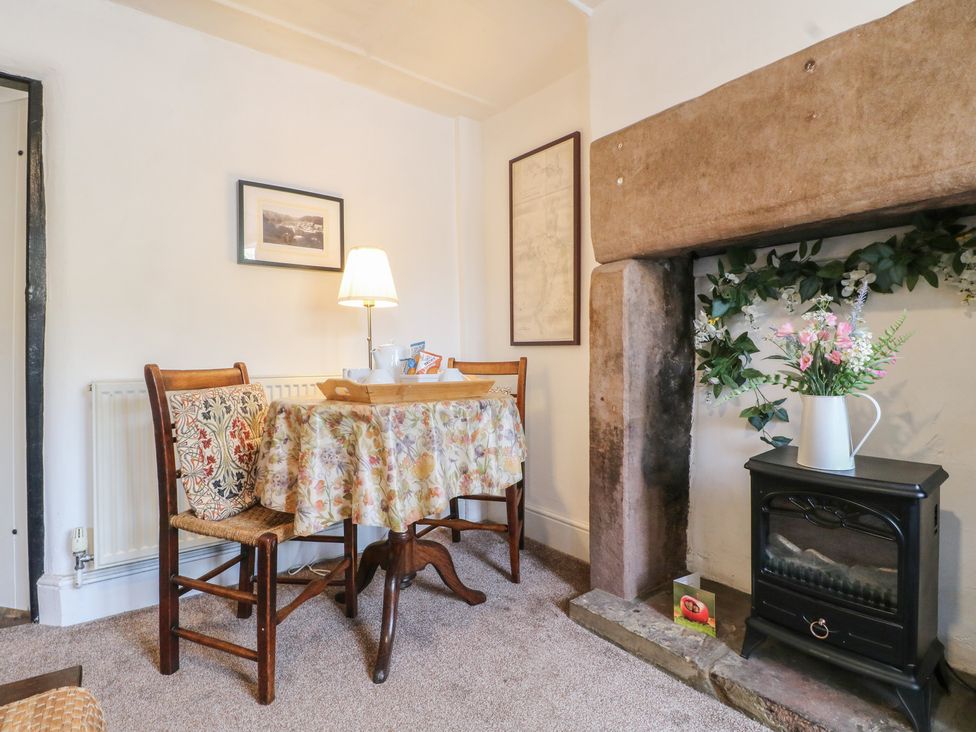 A dining room with a table and chairs at The Hill in Cromford