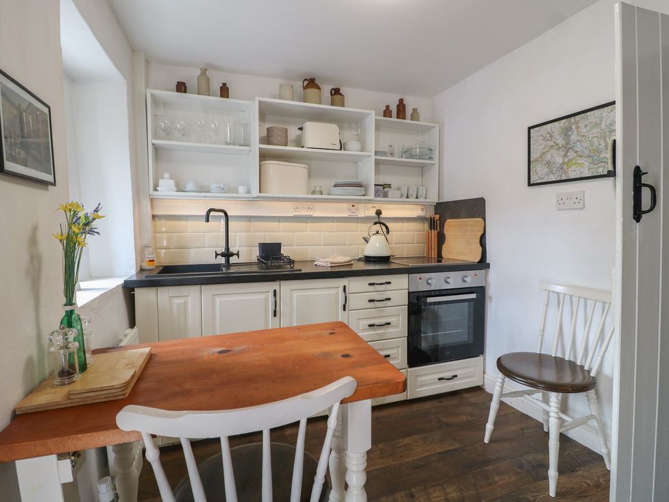 A kitchen with a table and chairs at The Hill in Cromford