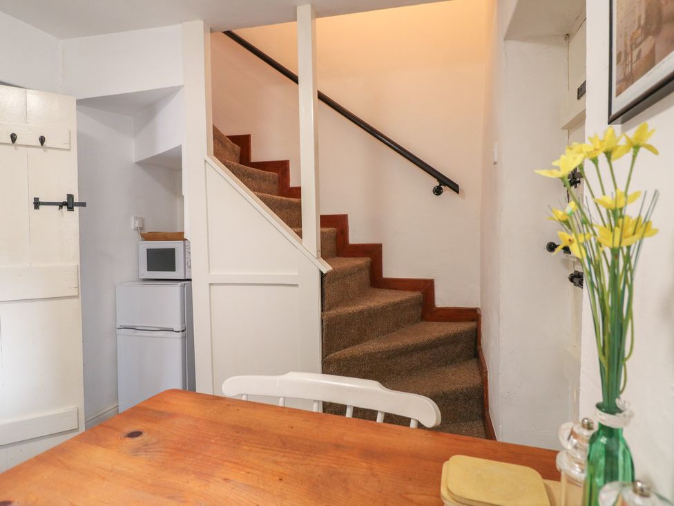 A kitchenette with a staircase and a microwave at The Hill in Cromford