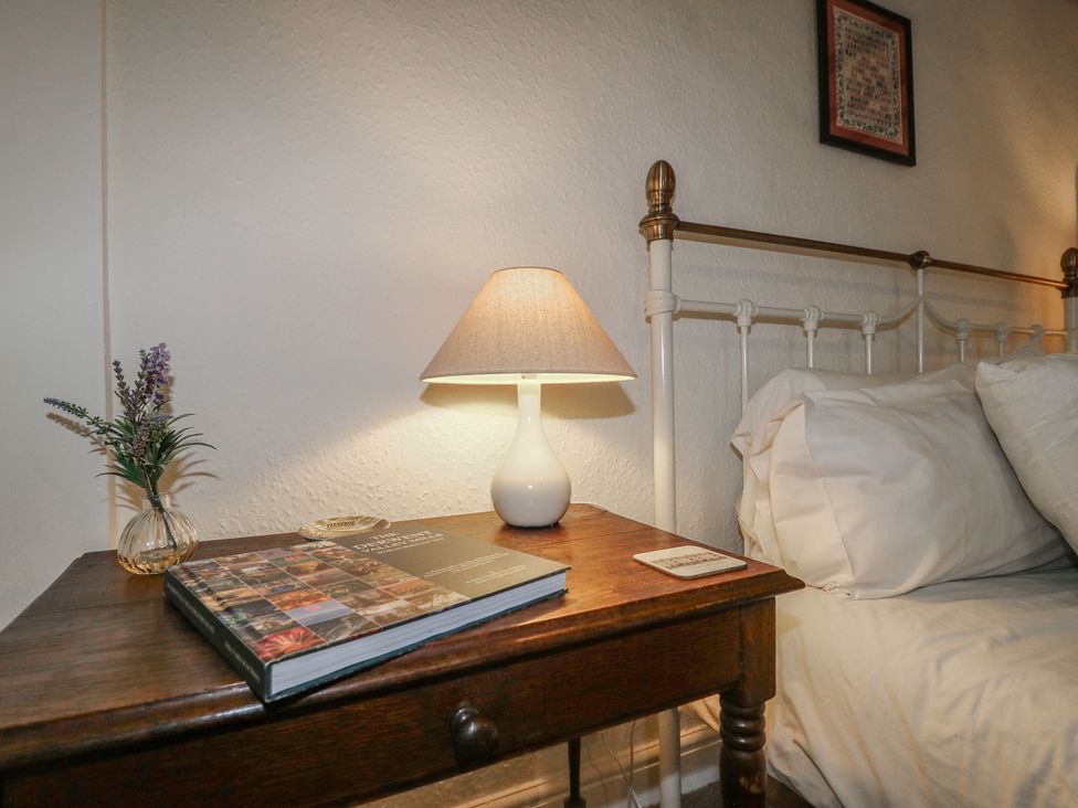 A bedroom with a bed and bedside table at The Hill in Cromford