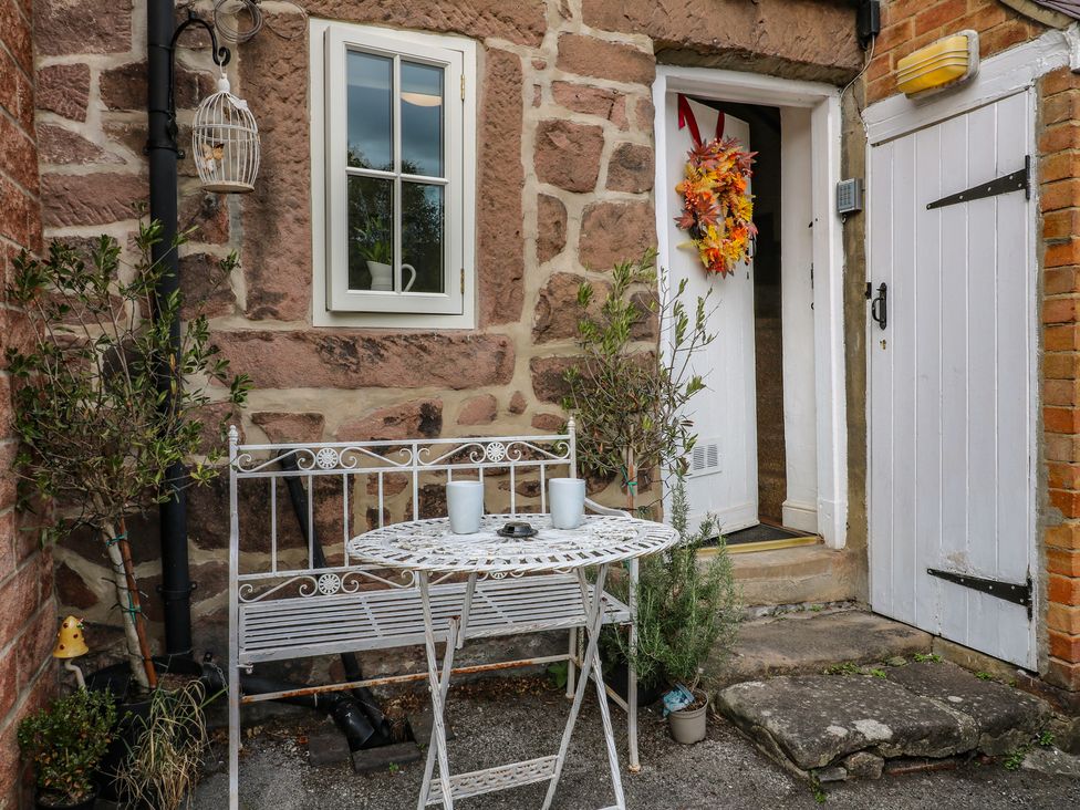An outdoor area with a bench and table at The Hill in Cromford