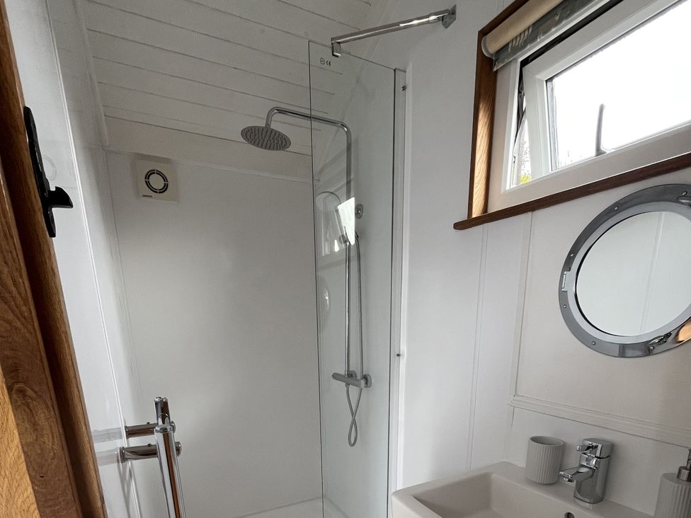 A bathroom with a shower and wash basin at Shepherds Cabin at Titterstone Clee Hill