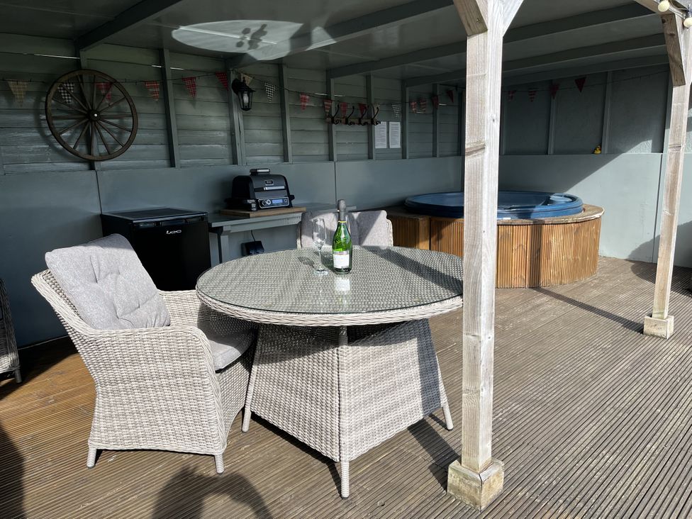 An outdoor space with a table and chairs at Shepherds Cabin at Titterstone Clee Hill