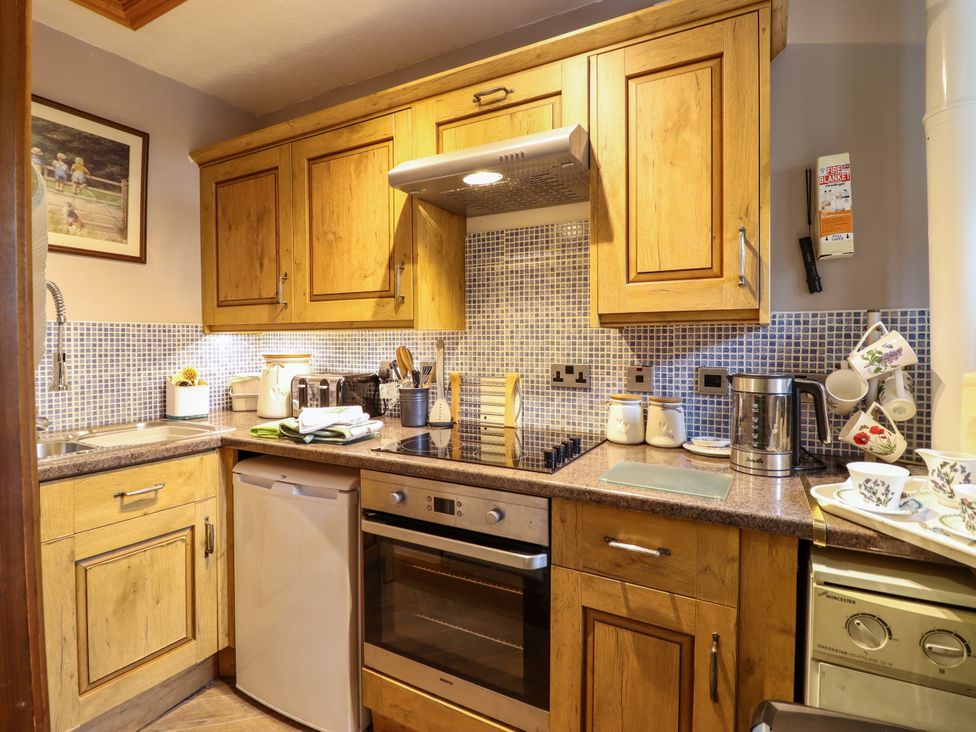 A kitchen with appliances and utensils at Gelli Glud in Eglwysbach