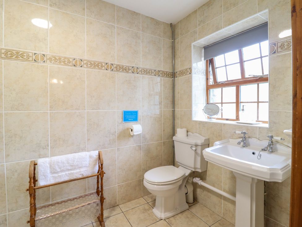 A bathroom with a toilet and sink at Gelli Glud in Eglwysbach