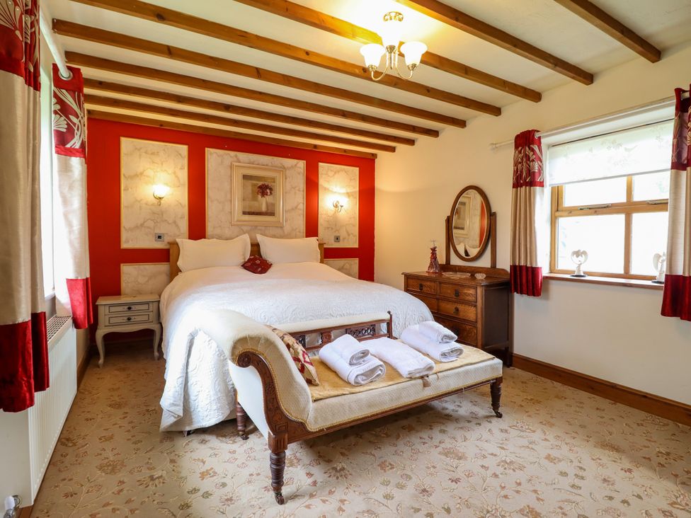 A bedroom with a bed and furniture at Gelli Glud in Eglwysbach