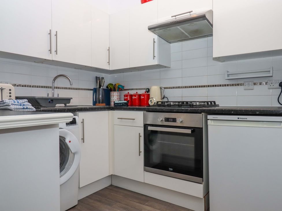 A kitchen with appliances and countertops at Cottage 1 Newcourt in Torquay