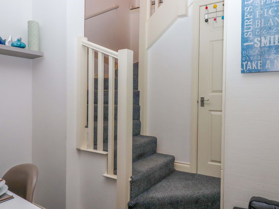 A staircase leading to an upper floor at Cottage 1 Newcourt in Torquay