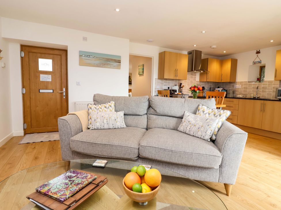 A living room with a sofa and fruit bowl at Cawsand in Tideford