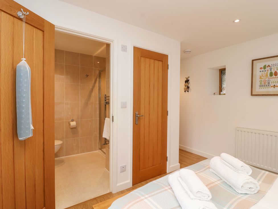 A bathroom with a shower and towels at Cawsand in Tideford