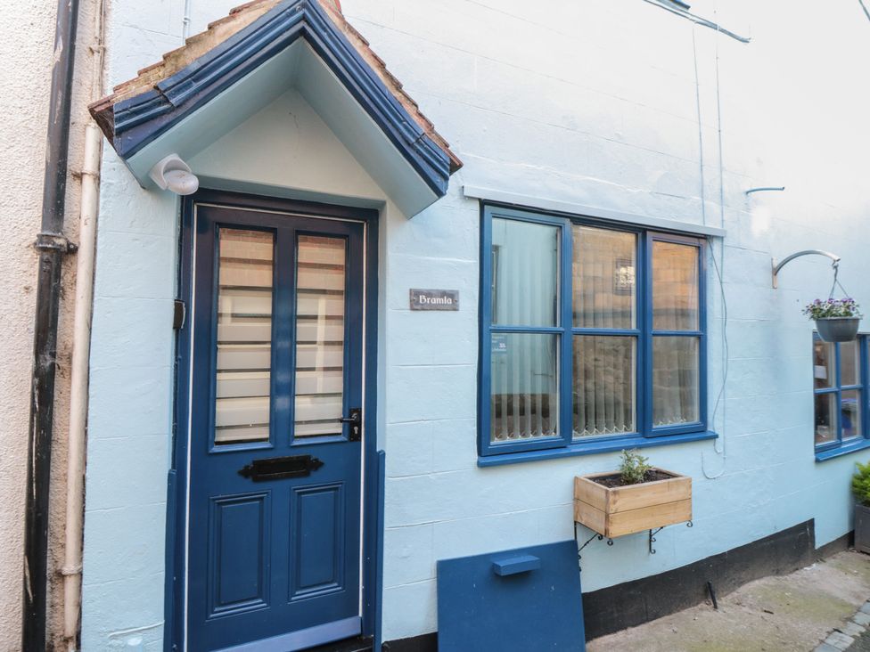 A blue door and window with planter at Bramla in Staithes